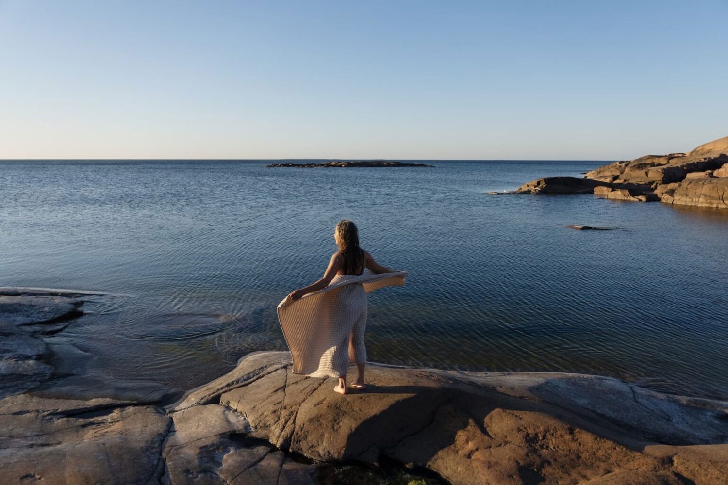 A person viewing the sea on the rocks