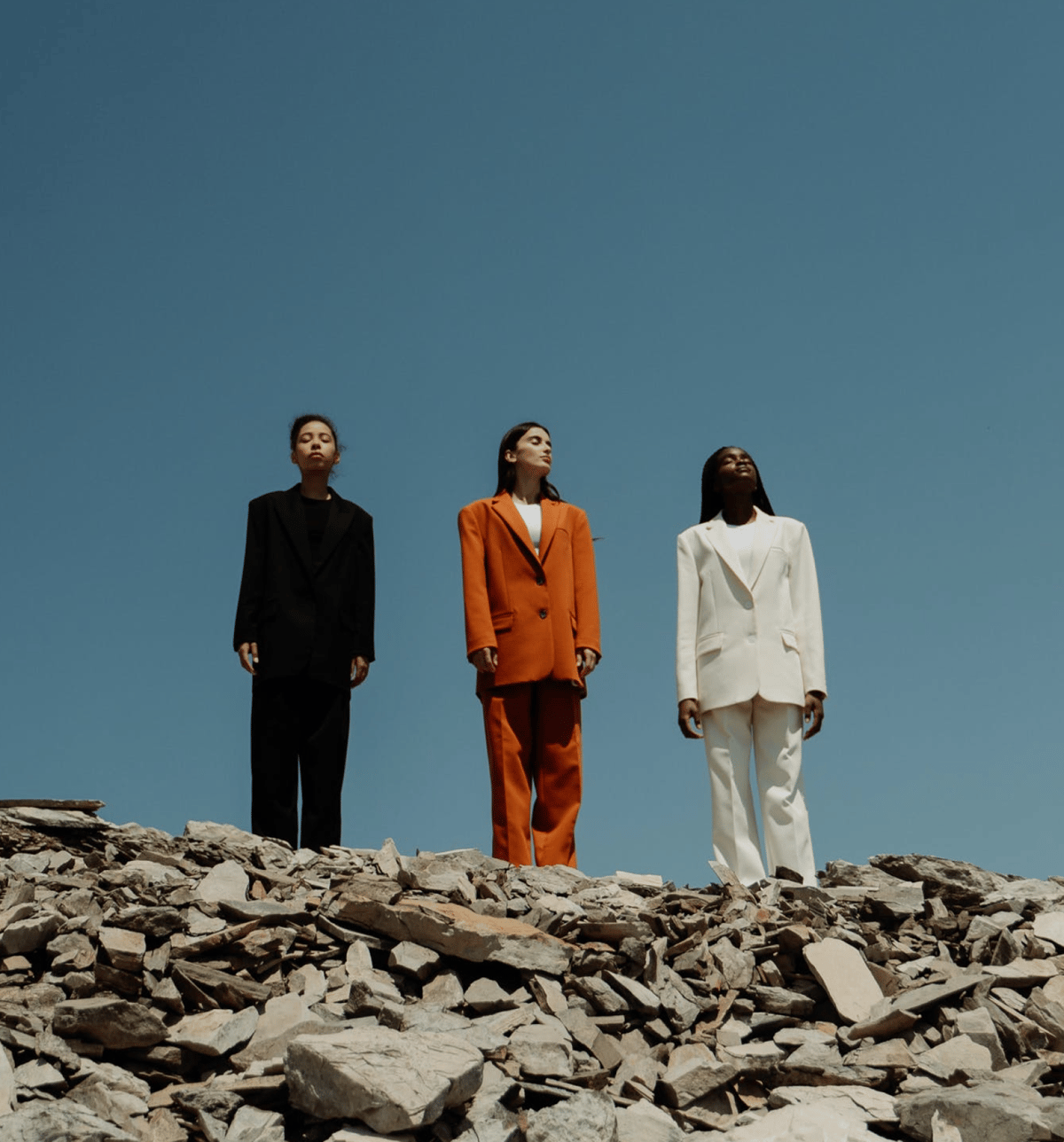 three women standing on a hill