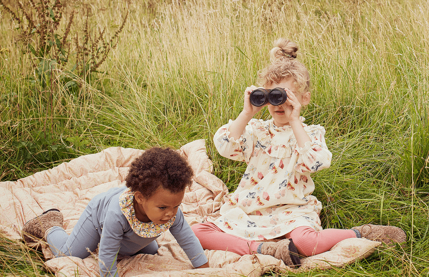 Children wearing Maisonette clothes playing in the grass