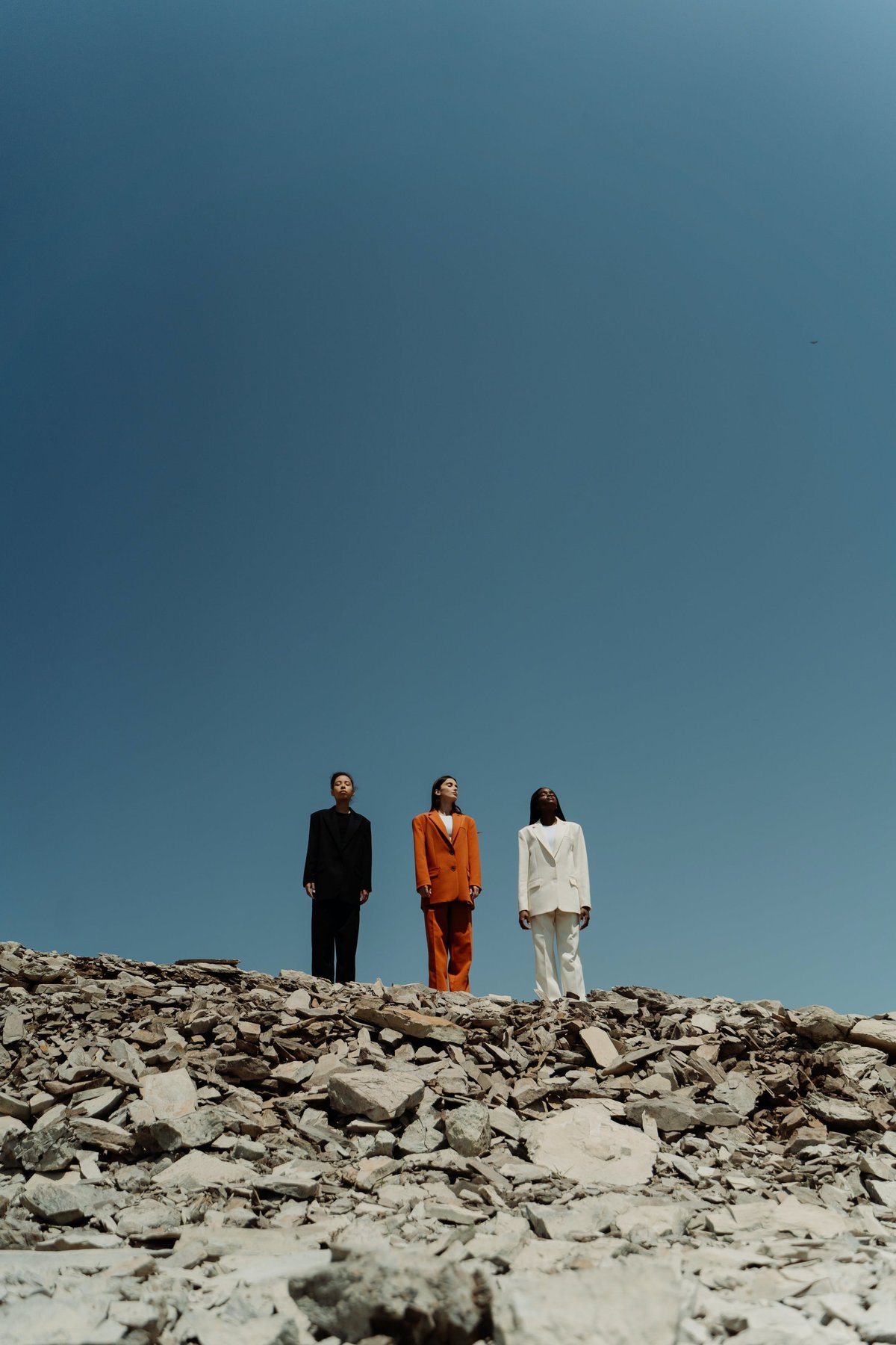 three women standing on a hill